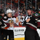 Trevor Zegras (second from left) is held back during a scuffle.